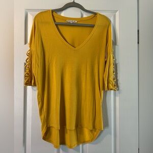 Yellow/Gold shirt with 3/4 length sleeves. Size small.